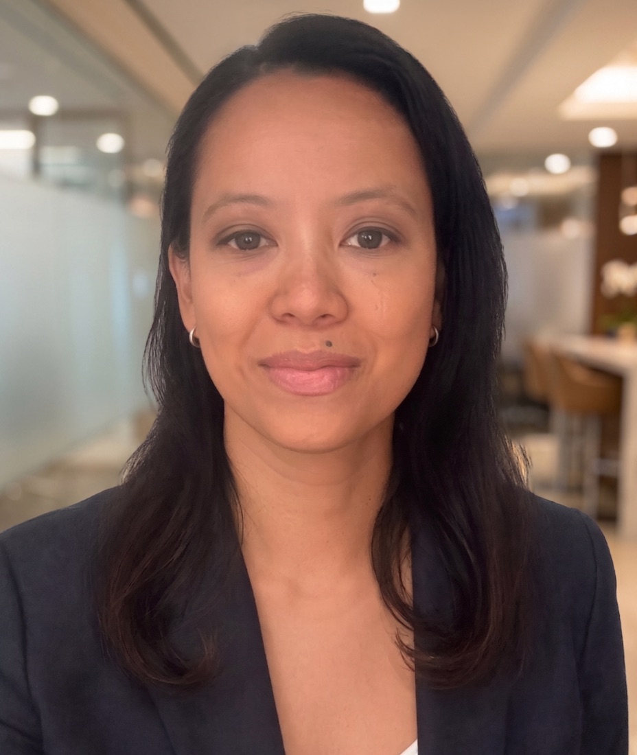 A photorealistic AI-generated portrait of a woman in an office — flagged as AI by VeriTrue
